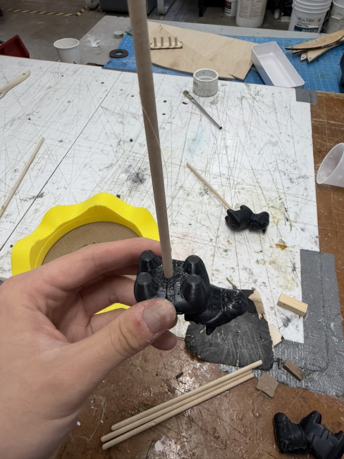 Calibration cat mounted upside down on a wooden rod
