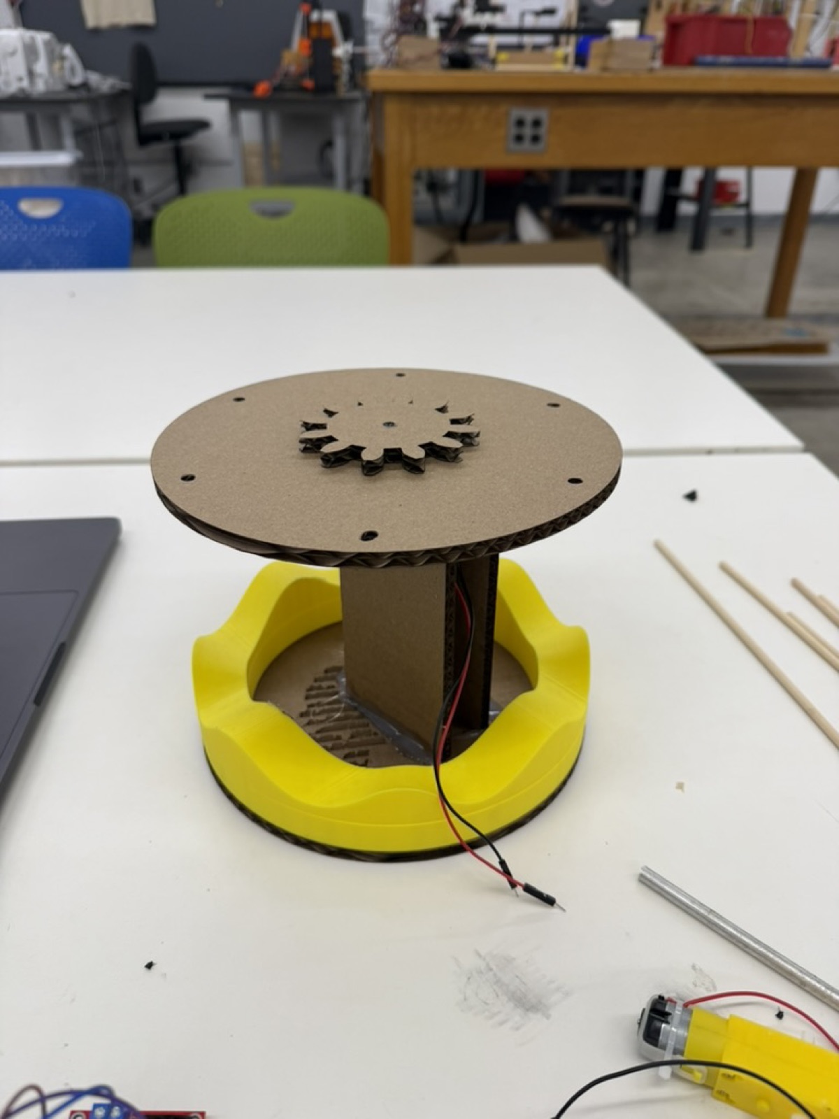 Early cardboard carousel assembly on top of the yellow wavy base