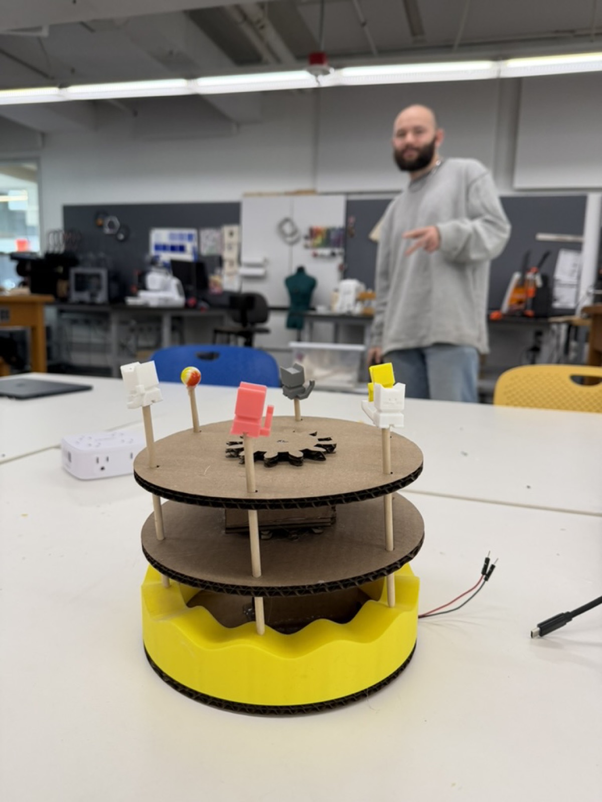 Completed kinetic sculpture with Bobby standing behind it in the lab