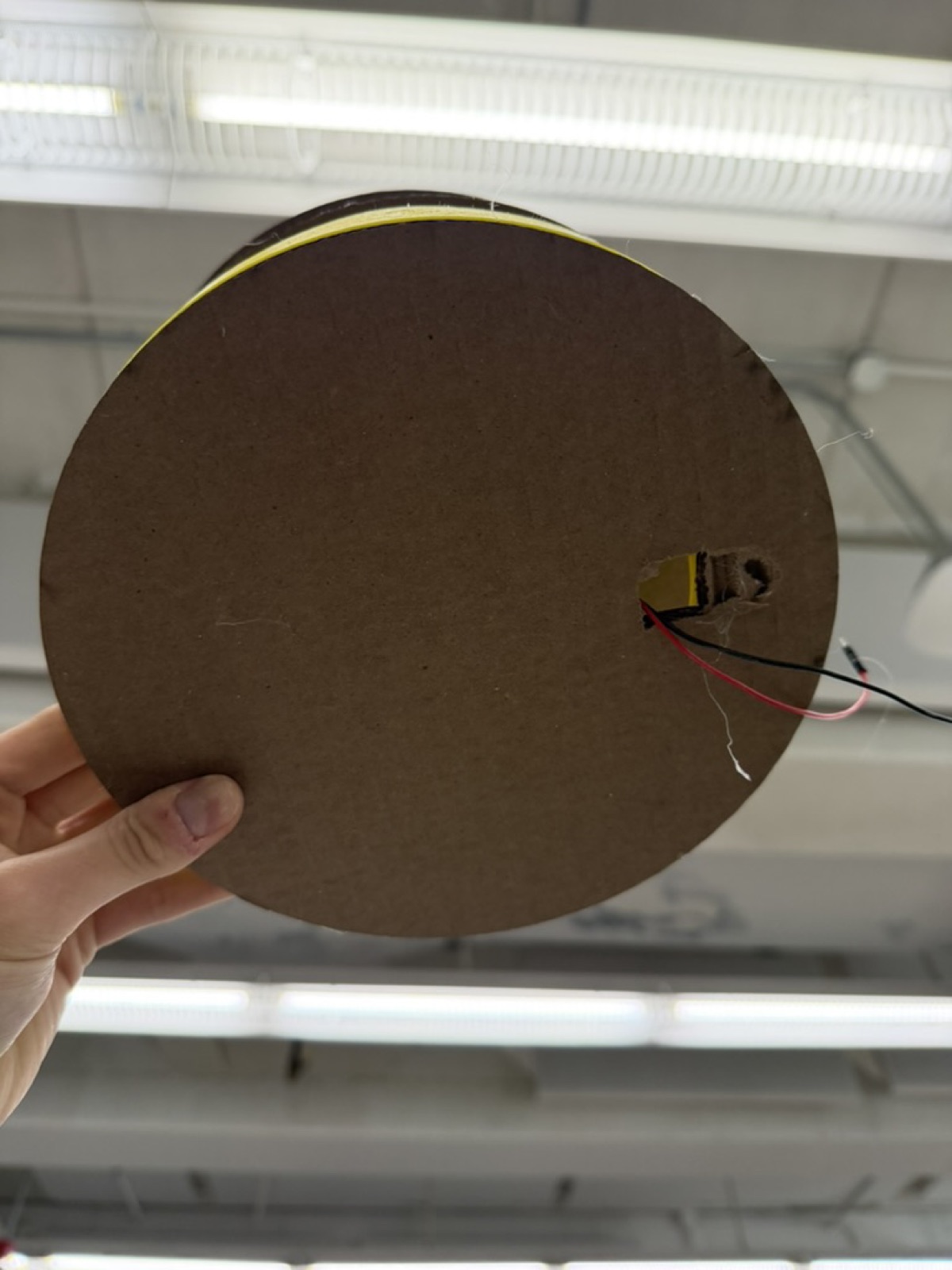 Hole cut into the bottom cardboard layer for motor wires