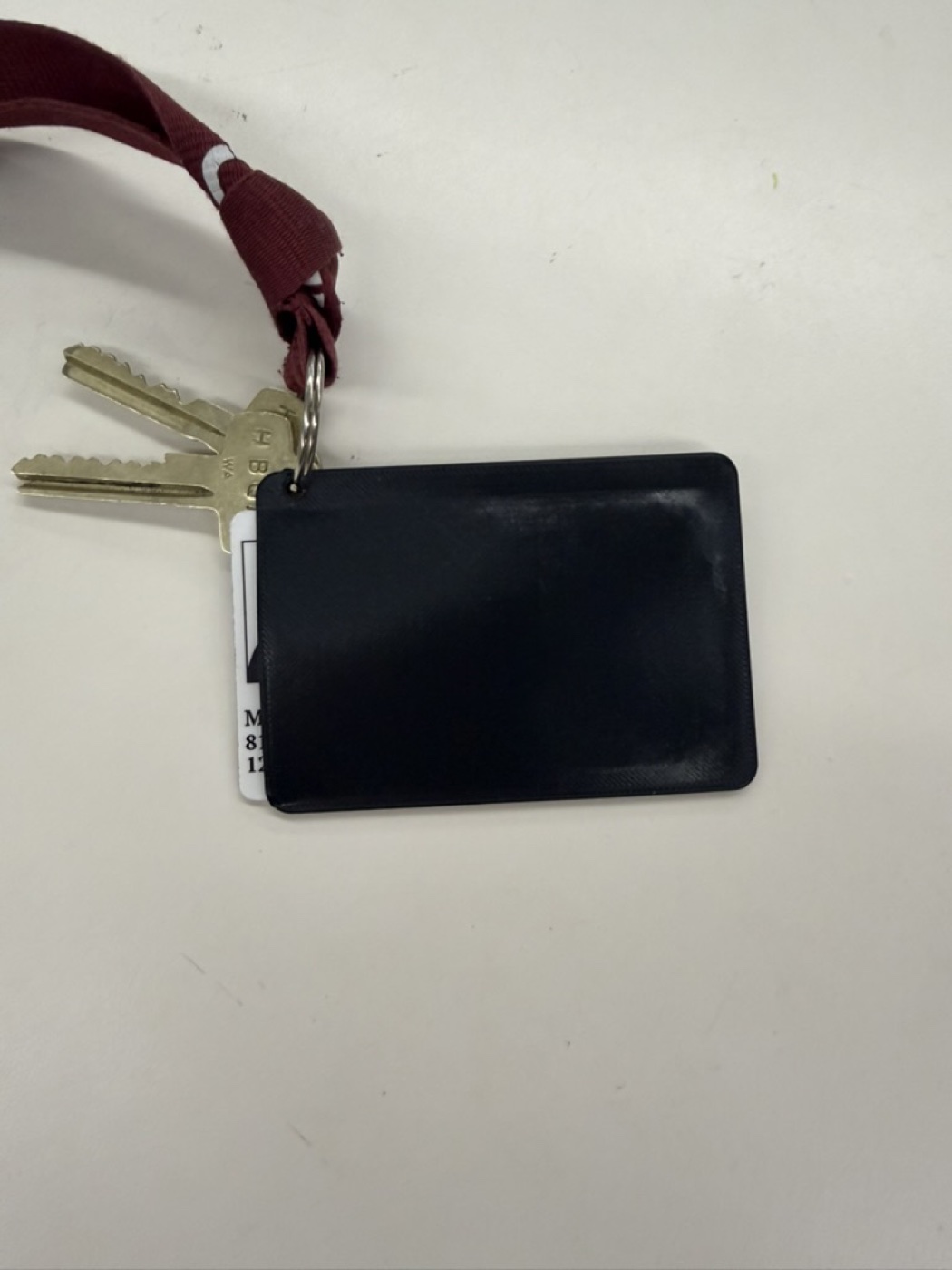 Finished black keycard holder attached to keys and a lanyard