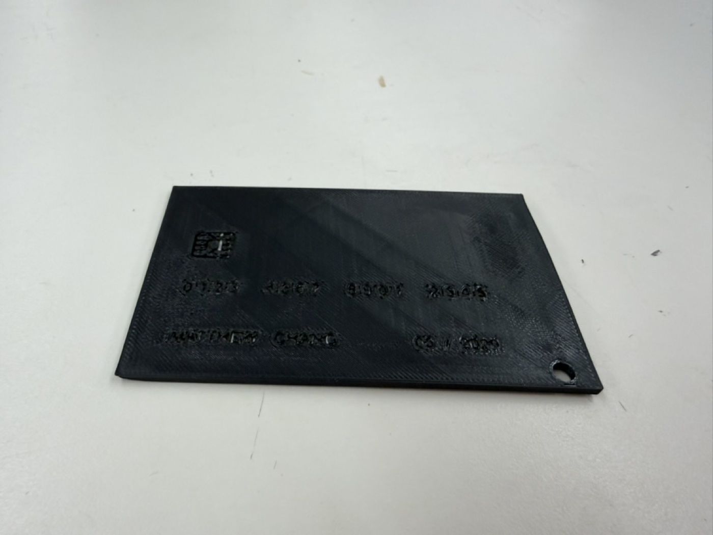 Finished black keycard holder with a chip graphic and engraved text