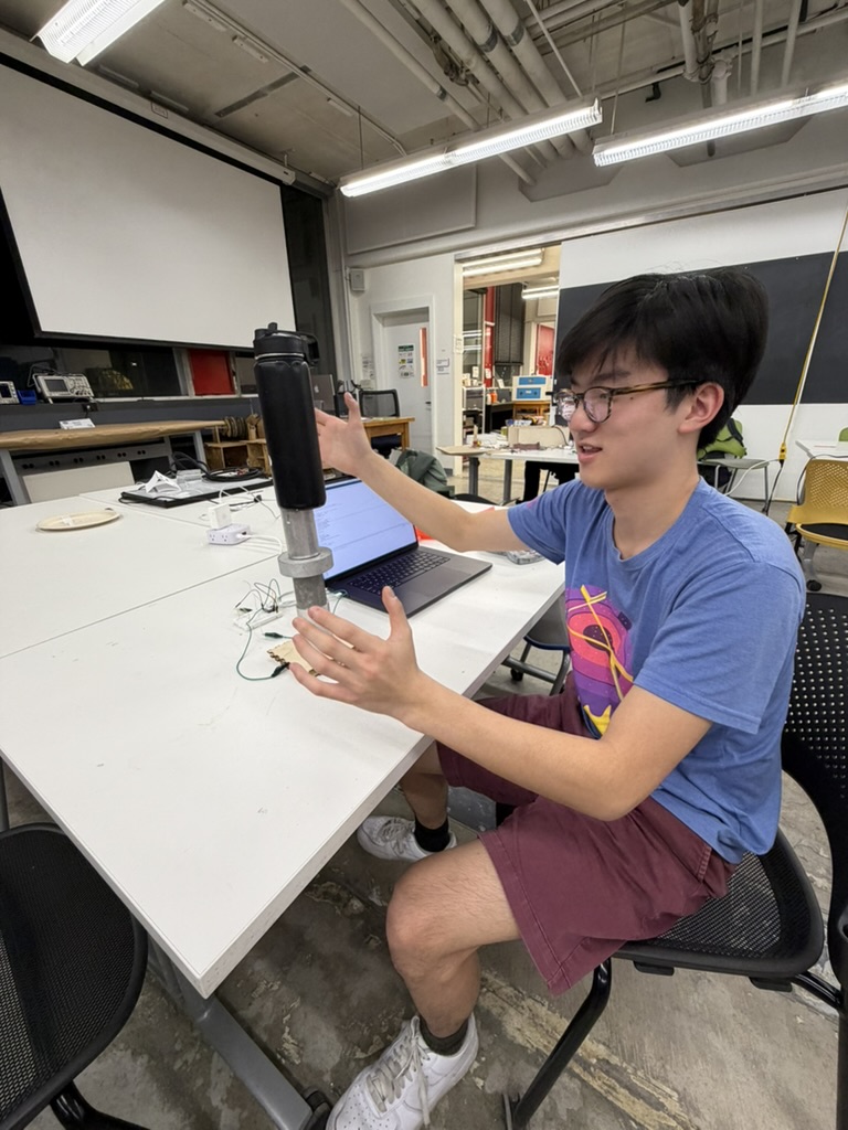 Water bottle added on top of a tall stack of metal weights for an extra high capacitive sensor calibration measurement