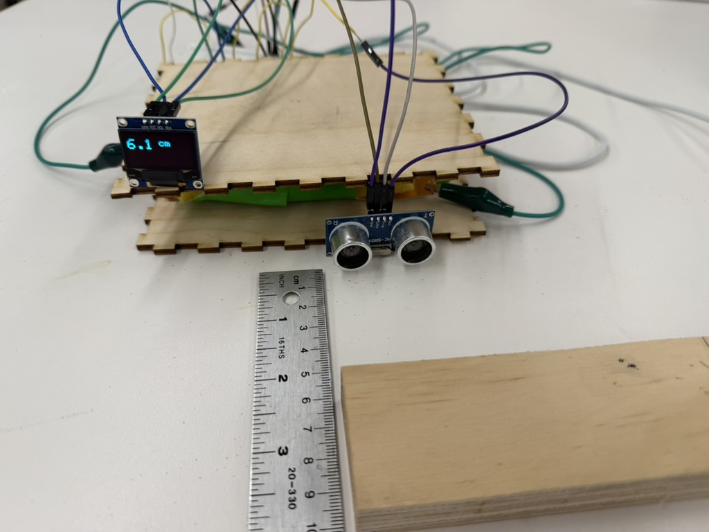 Completed ultrasonic sensor with OLED display calculating the distance from a wooden block