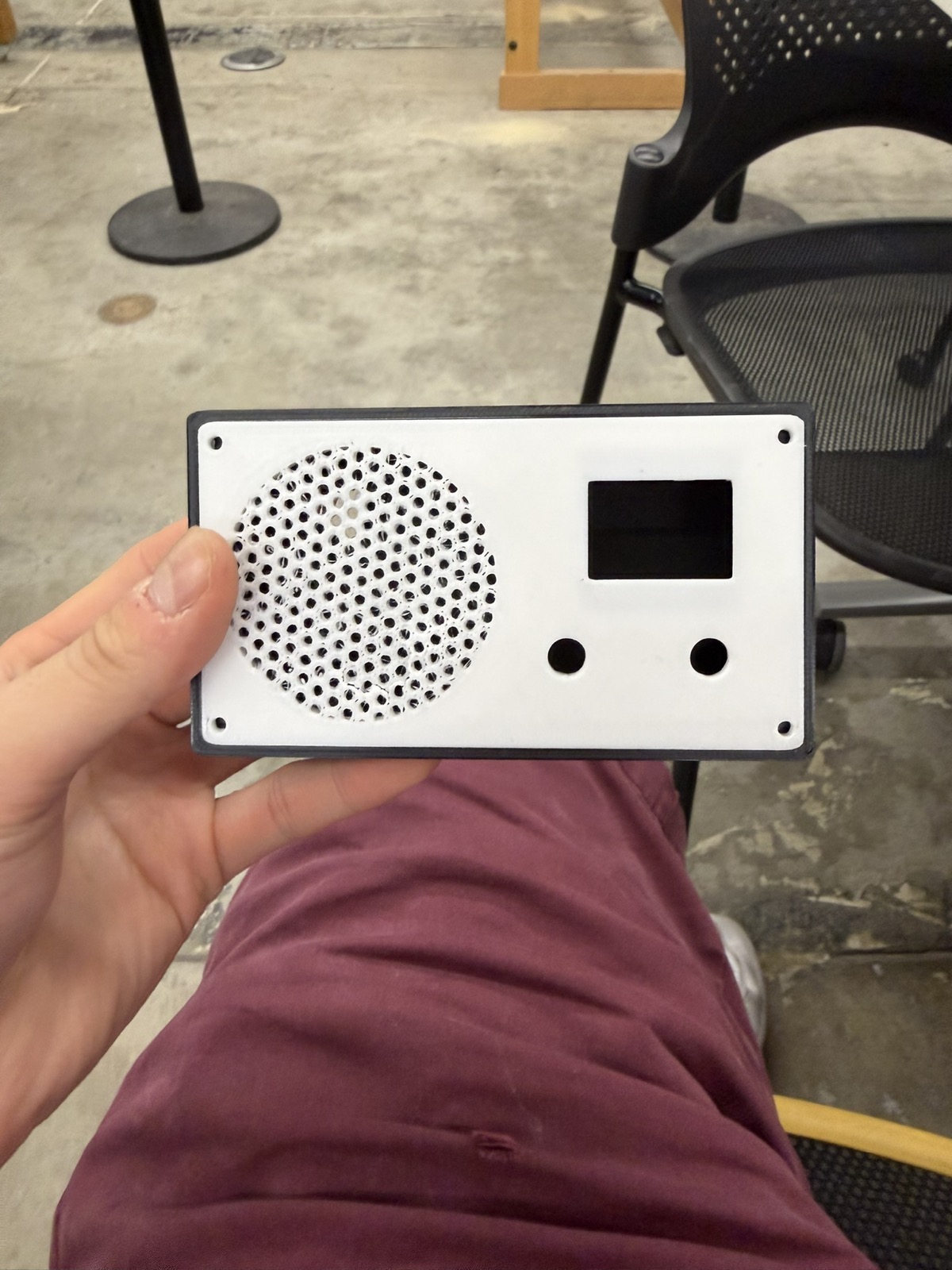 3D-printed radio enclosure with speaker grille, OLED cutout, and control holes