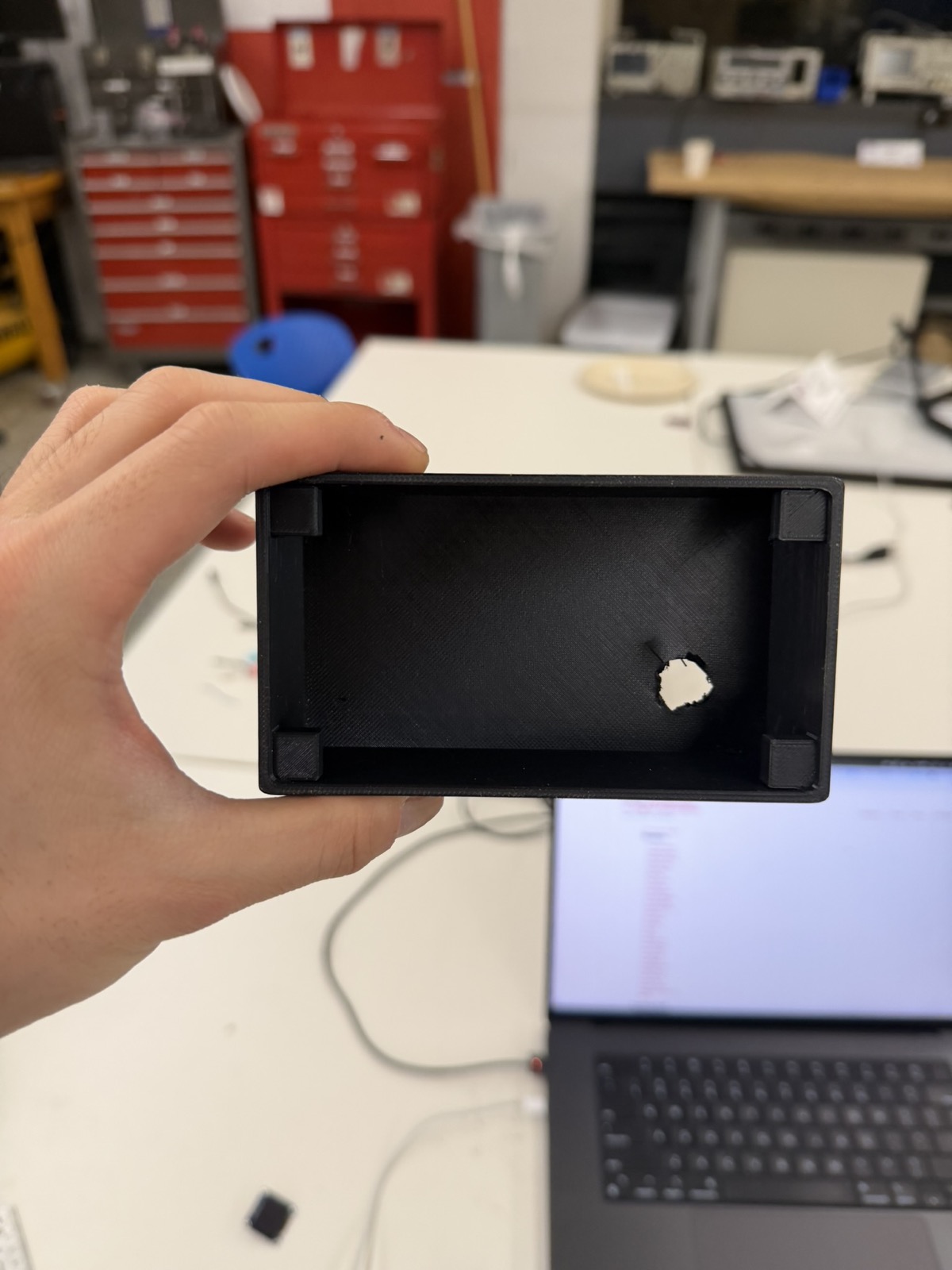 Rough drilled USB power cable hole in the back of the 3D-printed radio enclosure