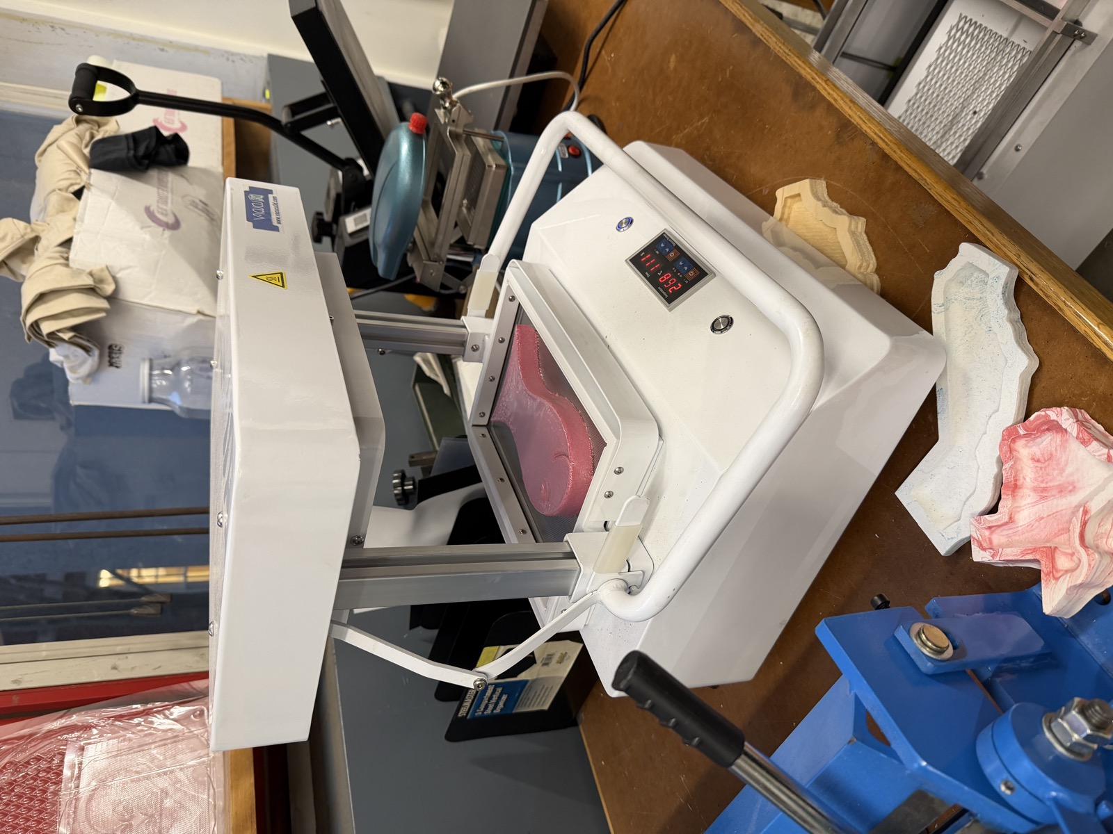 Vacuum former forming plastic over the pink foam goldfish