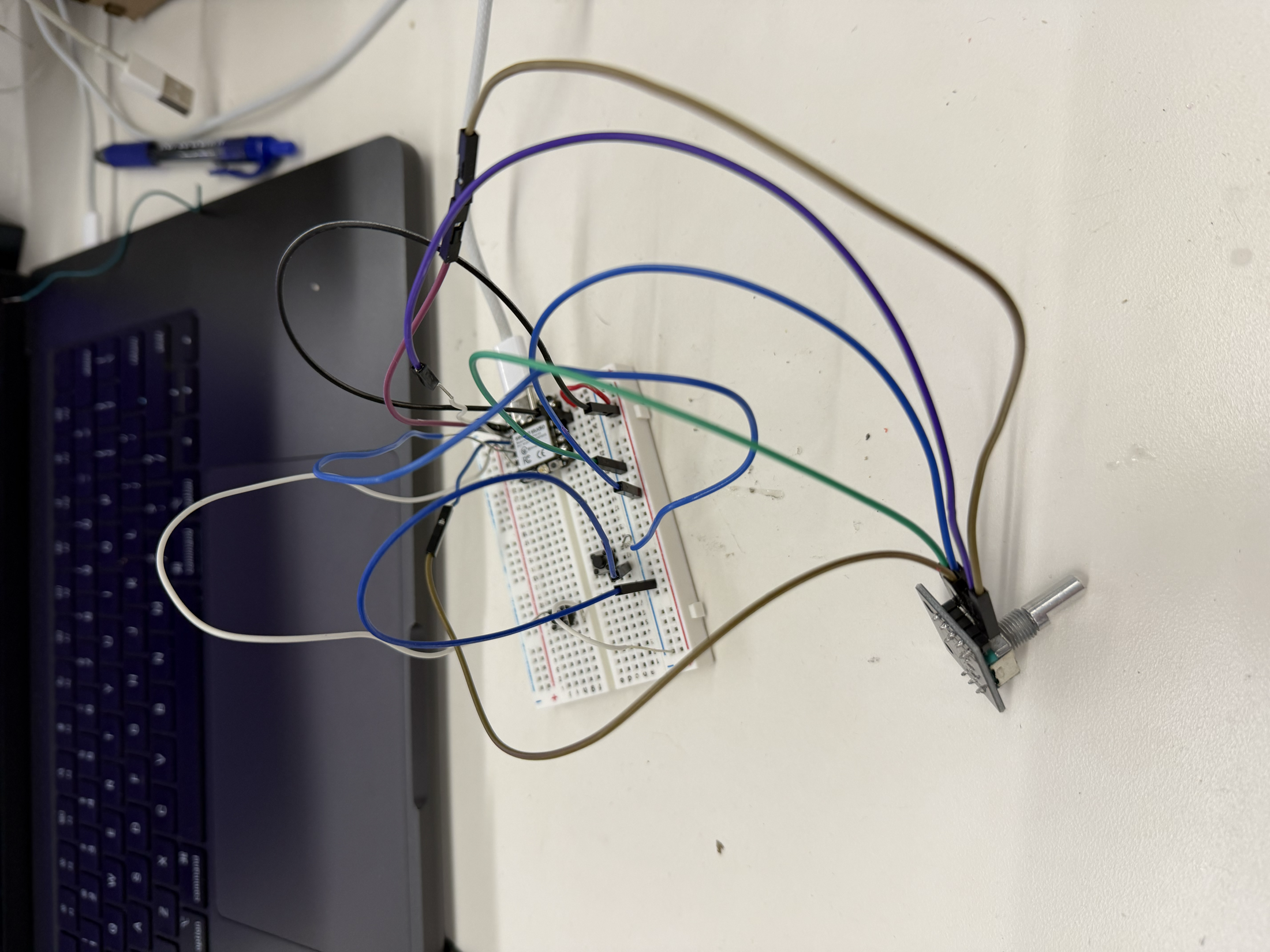 Wiring for the assembled remote with a XIAO, buttons, and rotary encoder on a breadboard before adding the LED