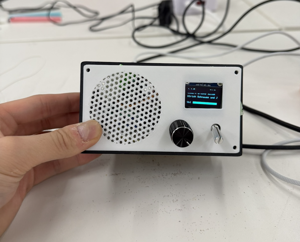 Completed radio MVP with OLED display, speaker grille, and controls