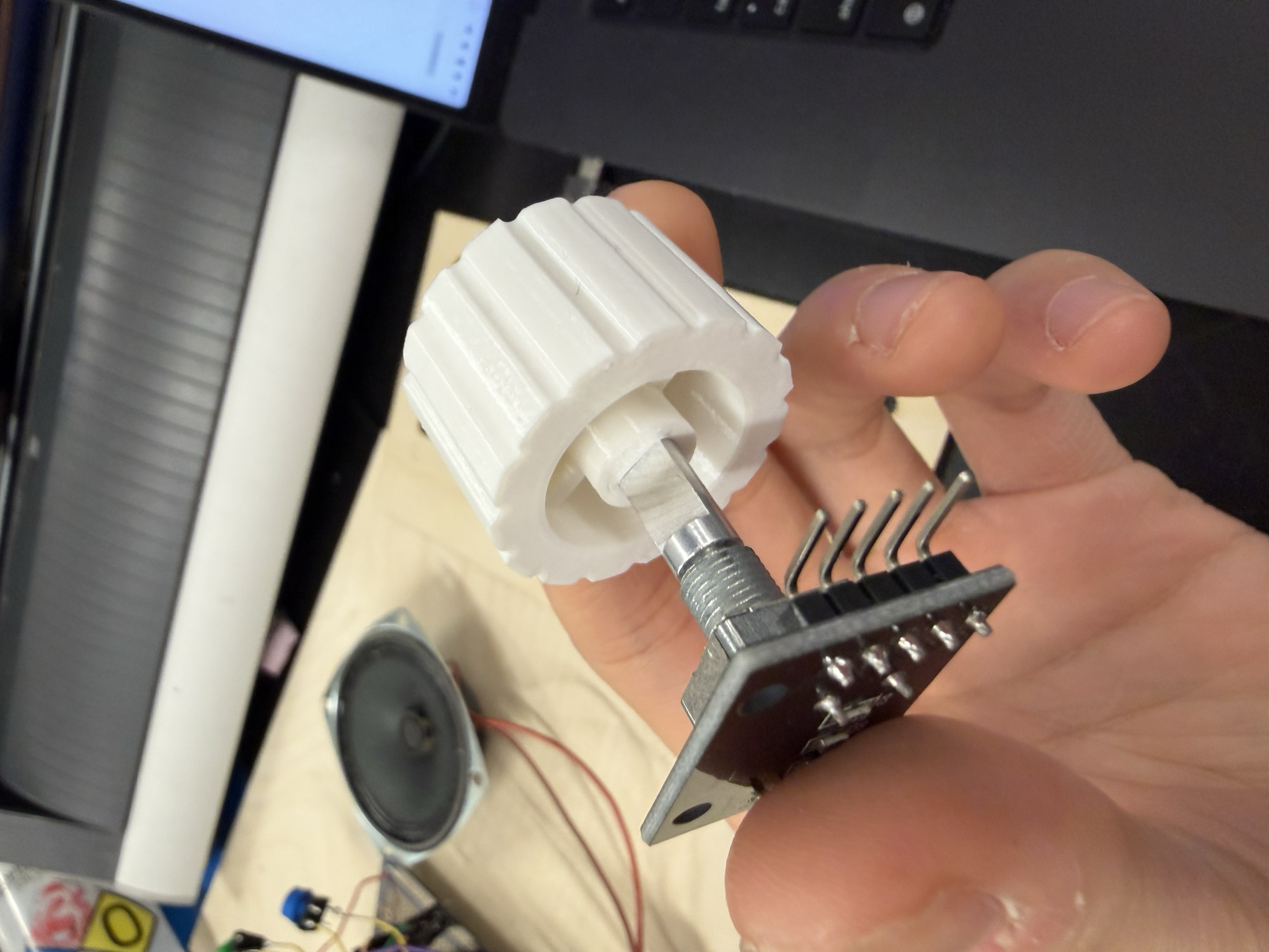 Press-fitting the 3D-printed knob onto the rotary encoder